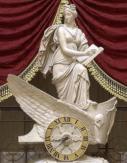 The Greek muse, Clio, stands on top of the “Car of History”  overlooking the Old House Chamber (Statuary Hall). Marble, Carlo Franzoni, 1819, courtesy of Architect of the Capitol. Image from the public domain website of the Architect of the Capitol.