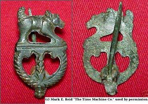 Zoomorphic fibula with dog. The pin was worn poining up. Illustration (C) used by permission.